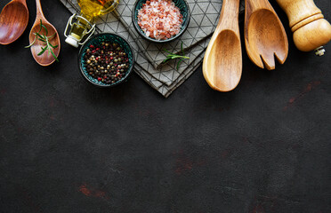 Old wooden kitchen utensils and spices as a border