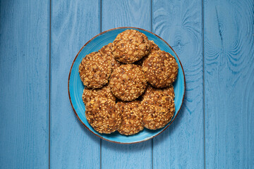 TOP VIEW: Oatmeal cookies on a blue plate on a blue table