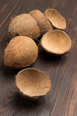 Whole coconut and coconut shells on board.