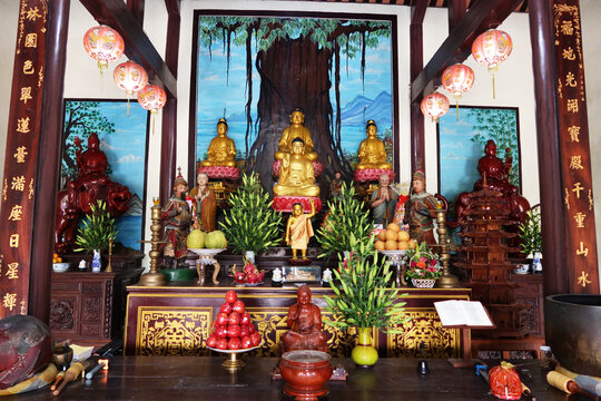 Hoi An, Vietnam, February 21, 2020: Altar with images of Buddha inside the Chùa Phước Lâm temple. Hoi An, Vietnam