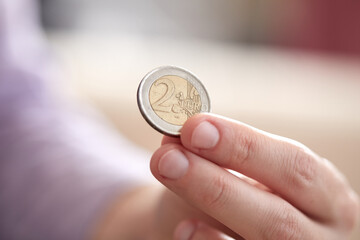 male hand putting euro coins