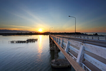 Fototapeta na wymiar Road bridge on the sea at sunrise, Thailand