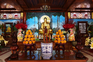 Hoi An, Vietnam, September 20, 2020: Altar with offerings of oranges in the main hall of the Tinh Xá Ngoc Cam temple. Hoi An, Vietnam