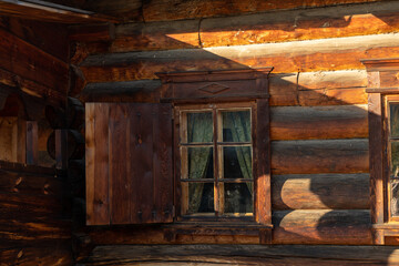 Obraz na płótnie Canvas Facade of a wooden building with a window.