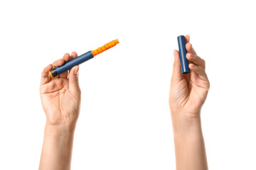 Female hands with syringe for insulin injection on white background. Diabetes concept