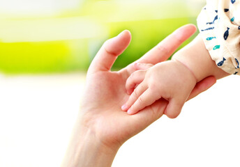母親と赤ちゃんが手をつなぐ　親子の触れ合い