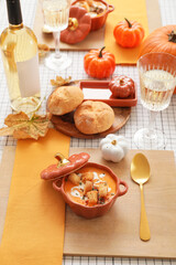 Tasty pumpkin cream soup in pot on table