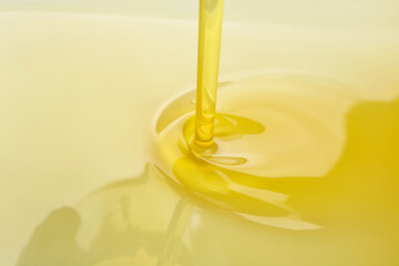 Pouring of olive oil, closeup view