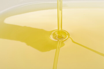 Pouring of olive oil, closeup view