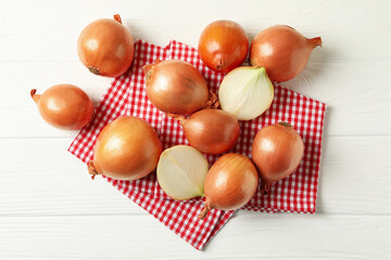 Napkin with fresh onion on wooden background