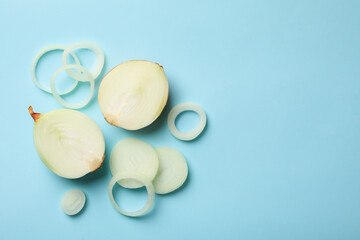 Fototapeta na wymiar Fresh onion on blue background, top view