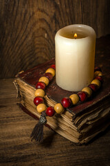 Spiritual still life, old book and wooden beads