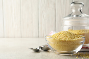 Concept of breakfast with couscous on gray table