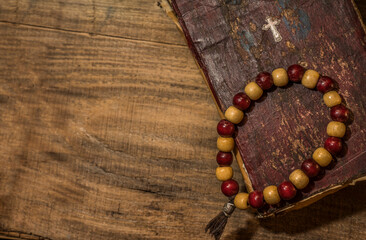 Spiritual still life, old book and wooden beads