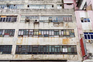 Residential area in old apartment with windows. High-rise building, skyscraper with windows of...