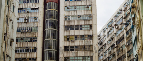 Residential area in old apartment with windows. High-rise building, skyscraper with windows of...
