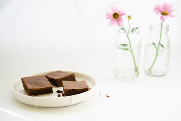 Composition for Easter greetings with flowers and brownie pie