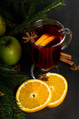 selective focus, hot drink, warmed red wine with fruit from oranges and apples, with spices of anise and cinnamon