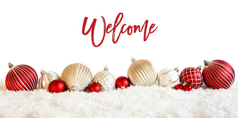 English Calligraphy Welcome On Isolated White Backgroud. Red And White Festive Christmas Ball Ornament On Snow.