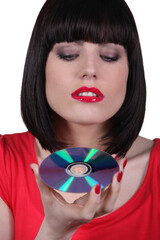 brunette woman looking a cd