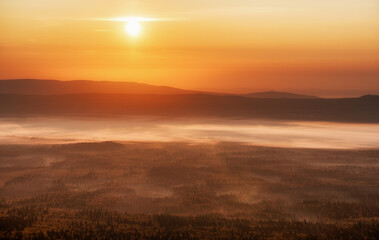 Orange sunset with the sun at the horizon setting down