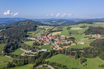 Fototapeta na wymiar Bild einer Luftaufnahme mit einer Drohne des Dorf Grueb bei Grafenau im bayerischen Wald mit Bergen und Landschaft, Deutschland