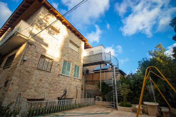 A small and narrow sukkah at the entrance to a beautiful two-story house in Jerusalem, Israel.