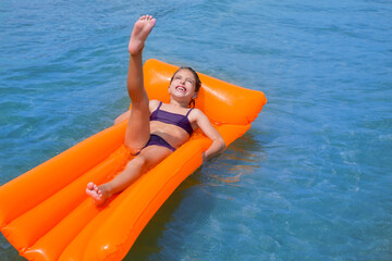 children kid girl playing in beach floating lounge