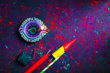 Diwali Diya with Fire Crackers over rangoli background