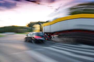 Dangerous city traffic situation with a car and a truck in motion blur