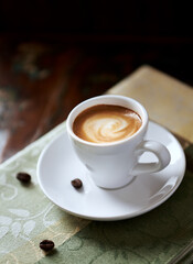 Cup of coffee on rustic wooden background. Close up.