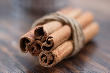 Cinnamon sticks on wooden table.