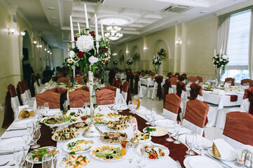 Banquet tables are served for guests in the elegantly decorated halls of the restaurant.