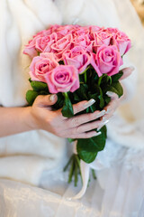 Obraz na płótnie Canvas bridal bouquet of pink roses, bride holding bouquet