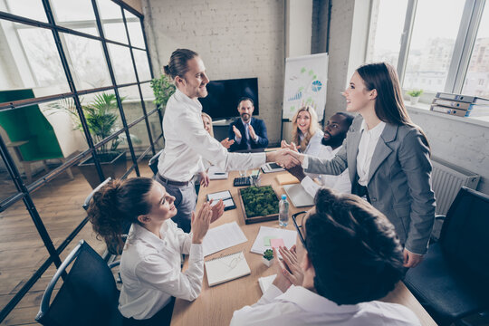 Photo of business people diversity age race partners anti crisis crash community handshake greeting new colleague member candidate teambuilding concept stand sit spacious office indoors