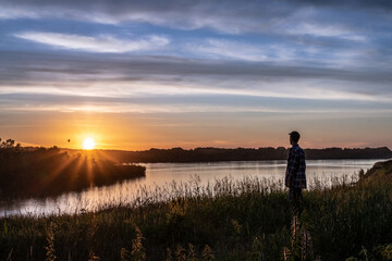 Watching beautifull summer sunset  on the river