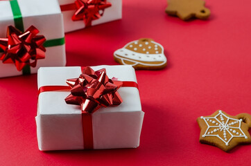 Christmas white handmade gift boxes on a red background tied with a red ribbon. Merry christmas,...