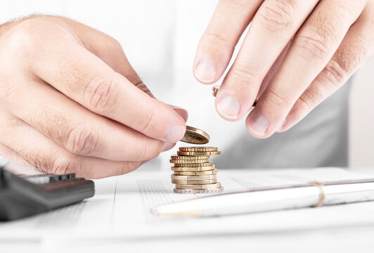 Businessman or accountant counting money and making stack of coi