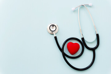 Stethoscope with red heart isolated on blue background, top view. Healthcare and medicine concept.