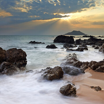 Dramatic seascape of Sea waves crashing against rocks in Krating Bay at beautiful sunset in Chanthaburi, Thailand, summer sea concept
