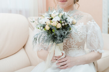 bride holding bouquet, winter bridal bouquet, bride in wedding dress