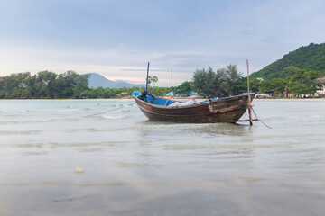 Naklejka na ściany i meble Fishing boat at the water's edge on Rayong beach, Thailand
