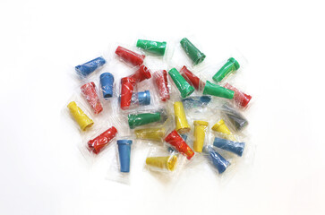 Single use plastic protective colorful mouth tips / caps / mouthpieces for shisha pipe for smoking in a hookah lounge or bar by different people. Used for sanitary purpose prevent the spread of germs