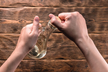 Bottle with cooking oil on the wooden kitchen table background.