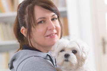 Woman wearing deaf aid with her dog