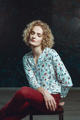 A portrait young blond man androgyne in the image of an attractive woman