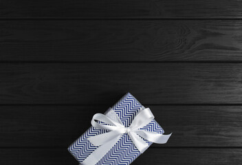 Fototapeta na wymiar gift box on a black wooden background