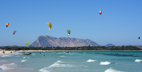 Italy / Sardinia �?? July 13, 2020: Brandinchi beach in Sardinia is wonderful for the color of the water and for the view of the very high island of Tavolara.