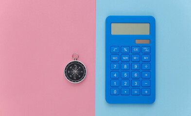 Calculator and compass on a blue-pink pastel background. Business concept. Top view