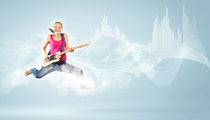 young woman playing on electro guitar and jumping